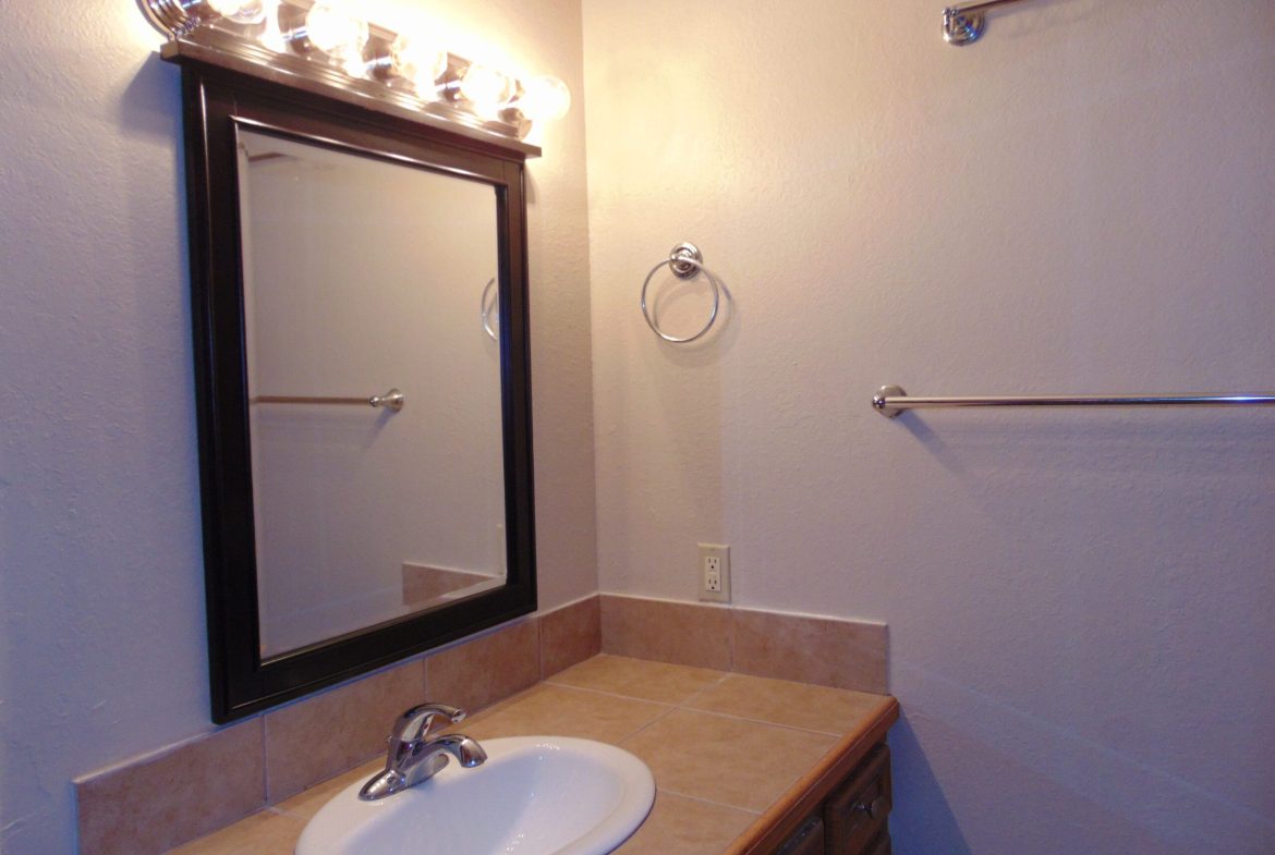 Bathroom vanity with mirror and sink.