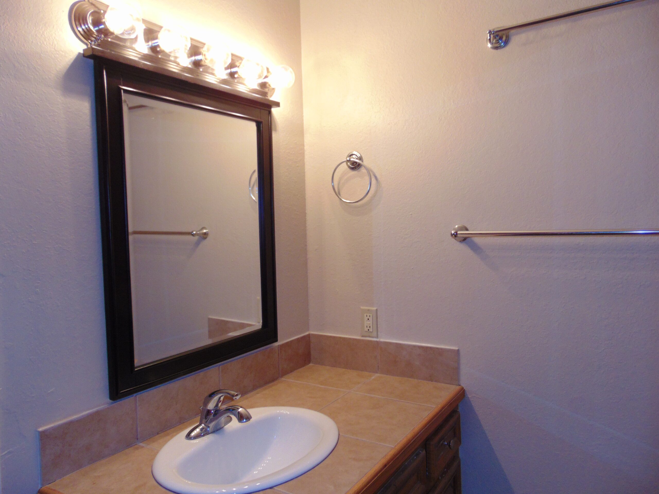 Bathroom vanity with mirror and sink.