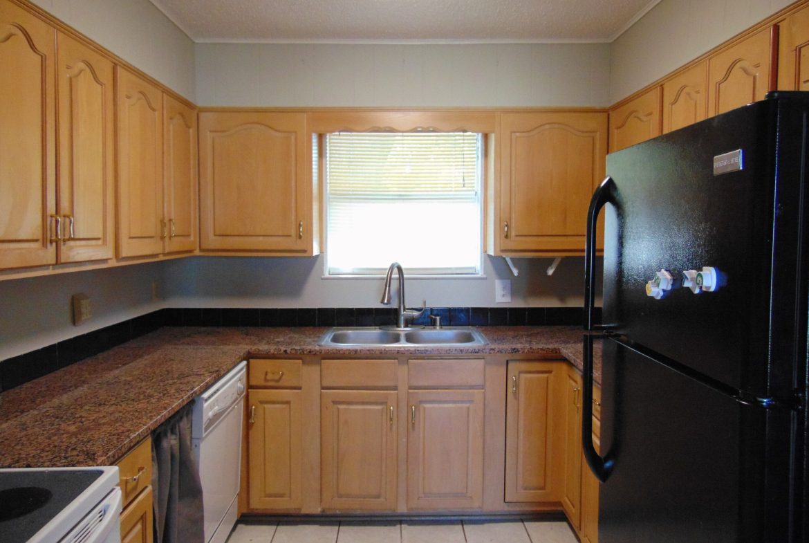 Kitchen with wood cabinets and granite counters.