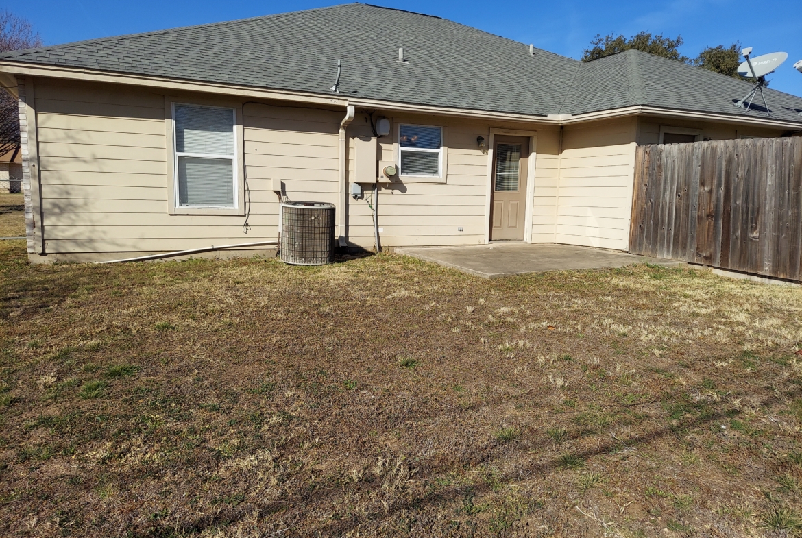 House's back yard with AC unit.