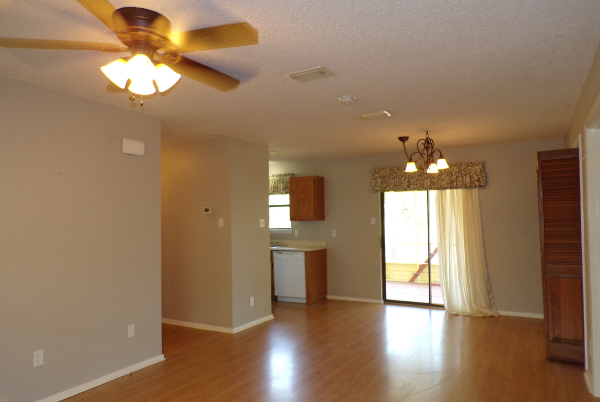 Empty living room with hardwood floors.