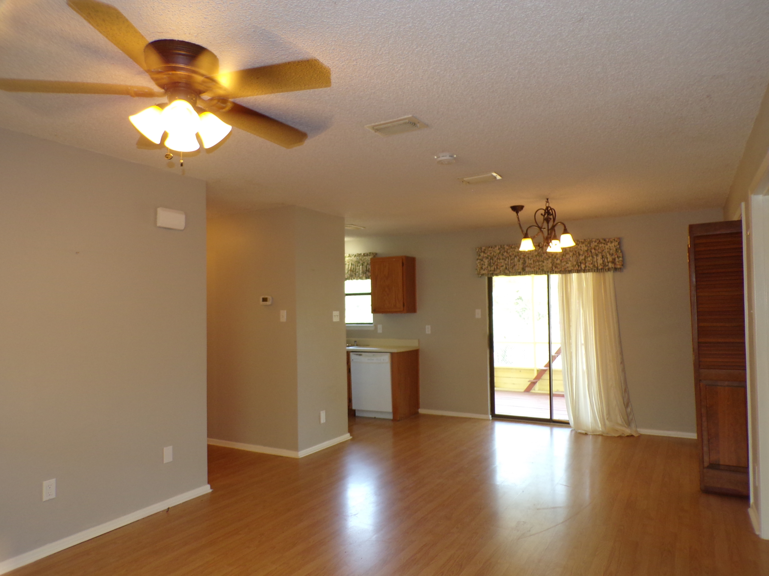 Empty living room with hardwood floors.