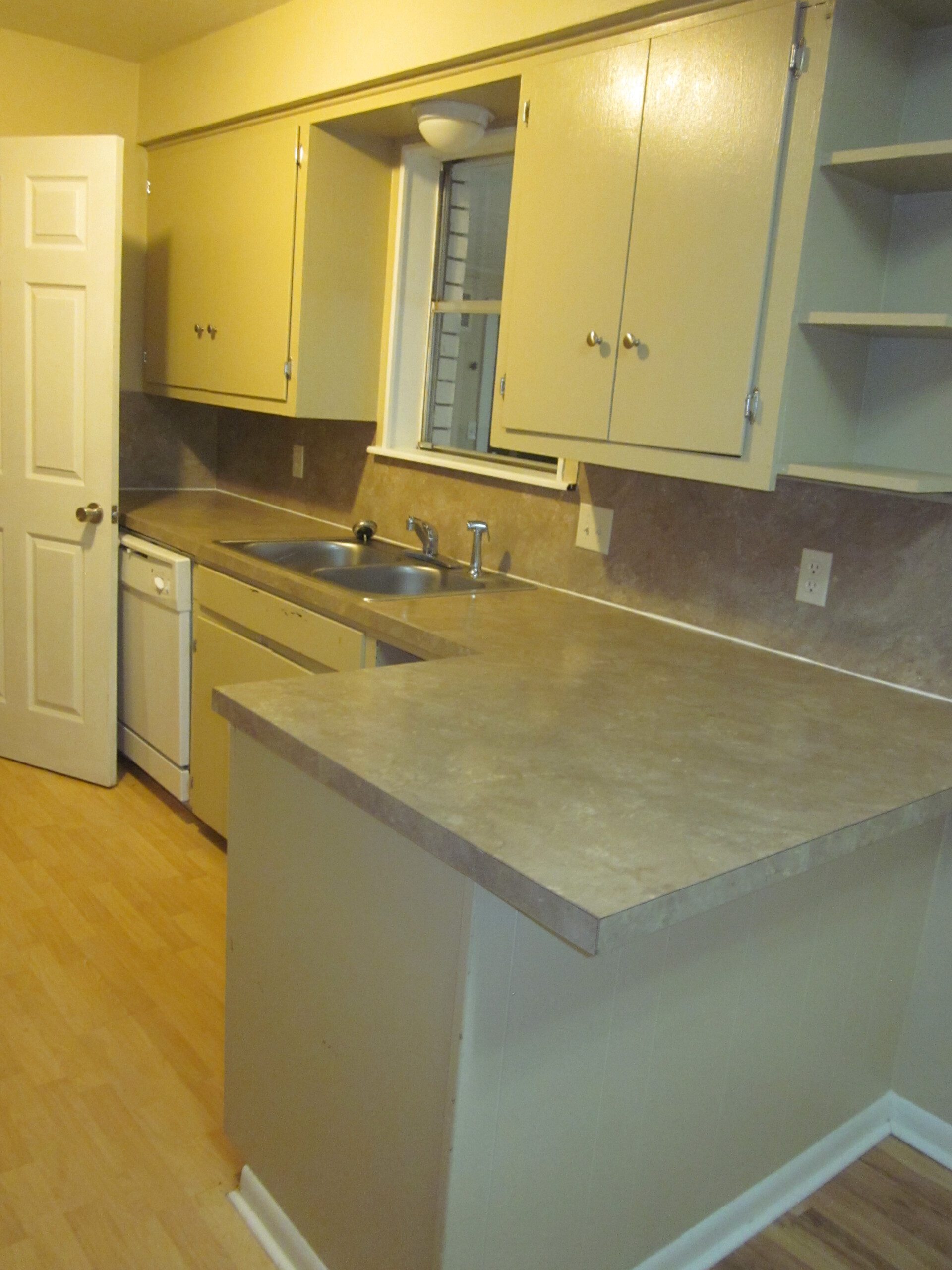 Kitchen with beige cabinets and countertops.