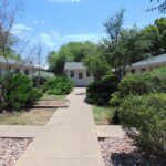 Walkway between apartment buildings and shed.