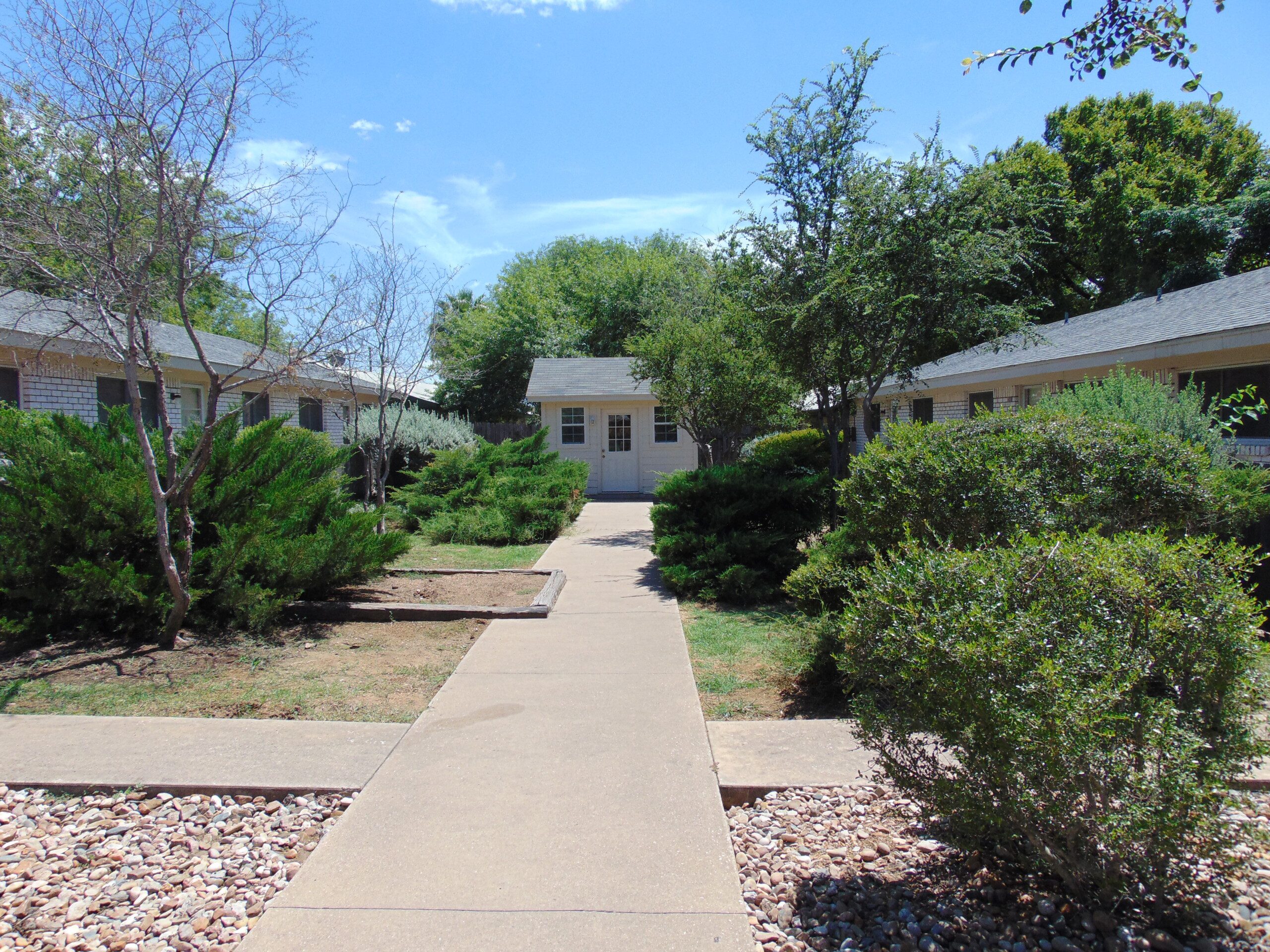 Walkway between apartment buildings and shed.