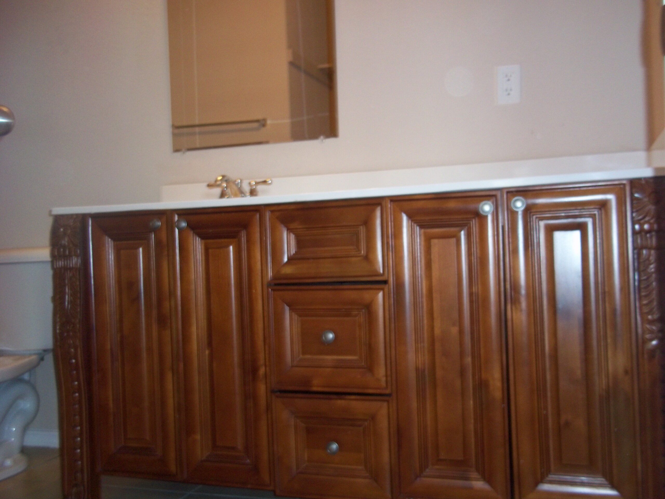 Dark wood bathroom vanity with drawers.
