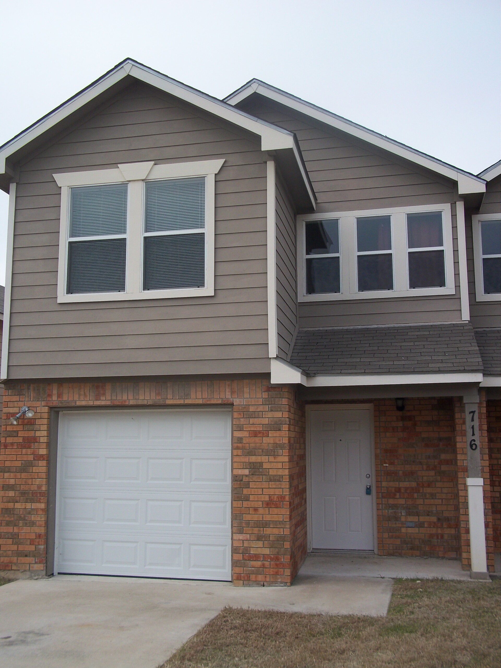 Two-story house with attached garage.