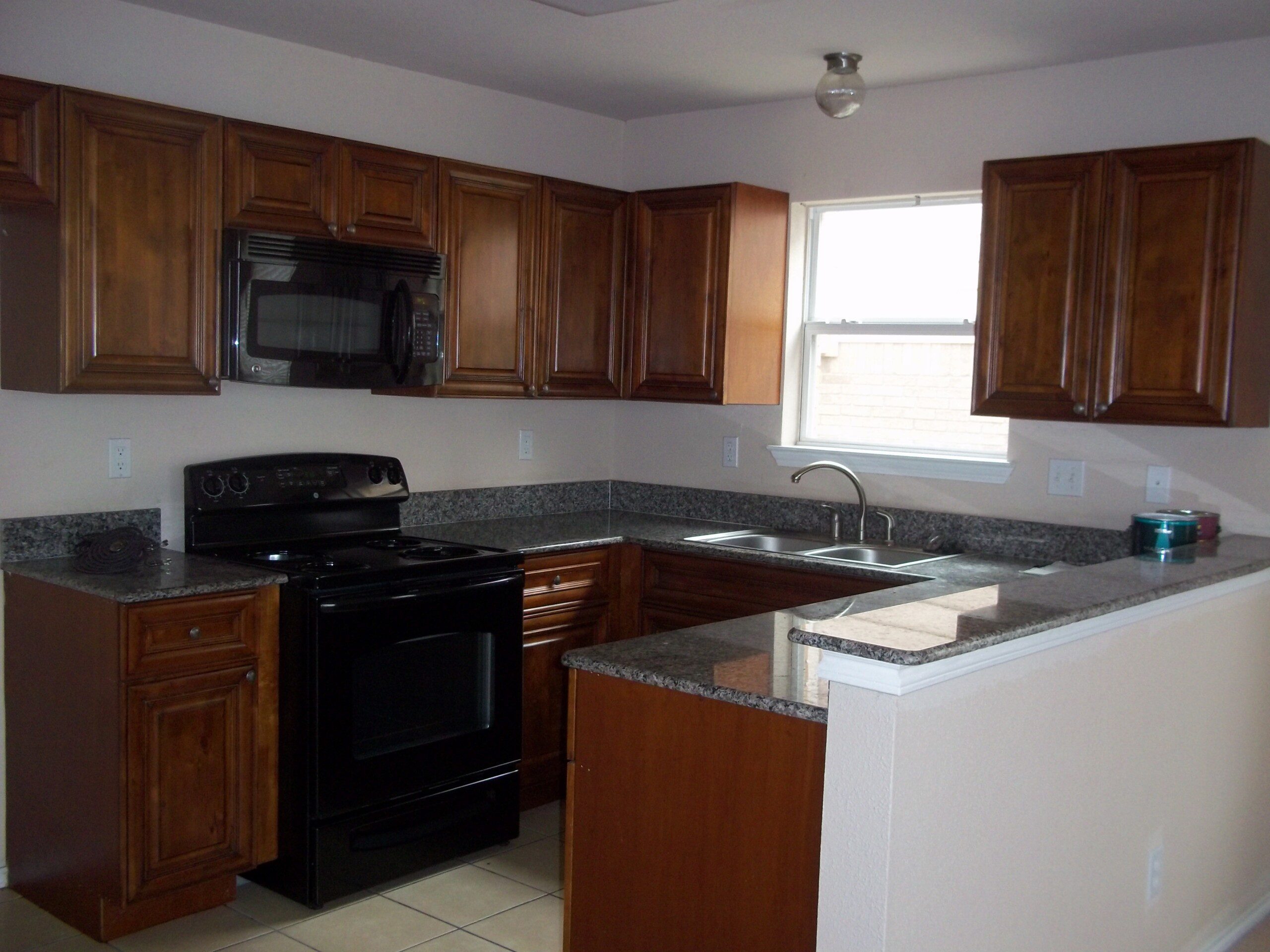 Modern kitchen with dark wood cabinets.