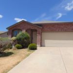 Brick ranch house with attached garage.