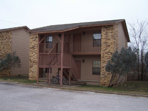 Two-story apartment building with bike.
