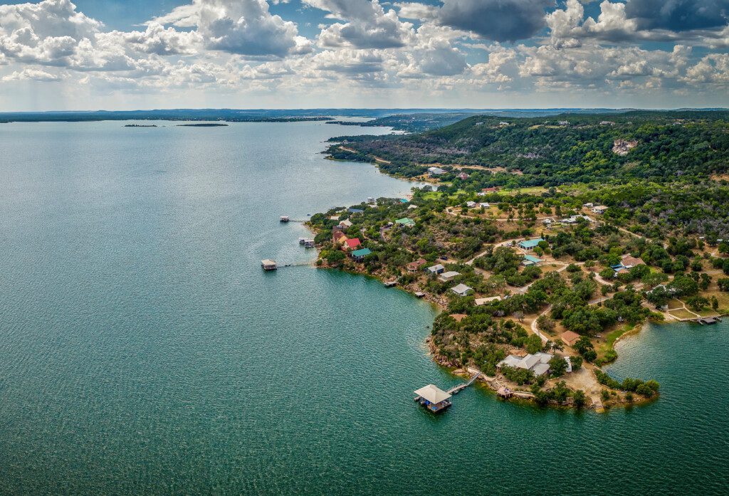Lakefront homes and cloudy sky.