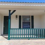 Here's an alt tag for the image: Building entrance, porch, green railing, 904.