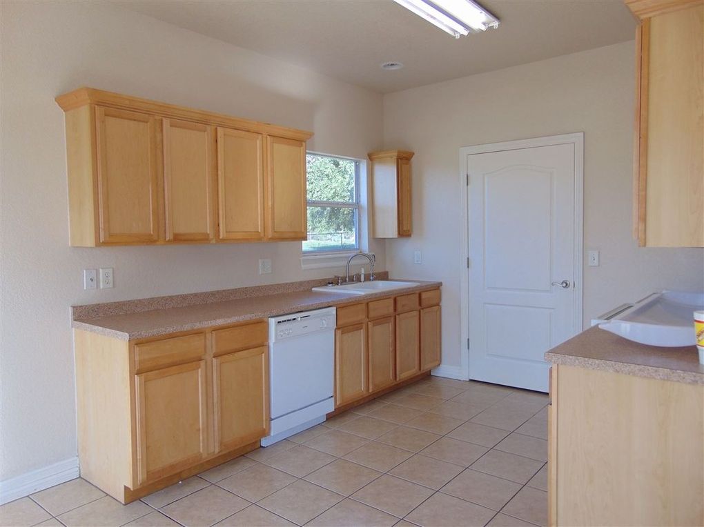 Light wood kitchen with tile floor.