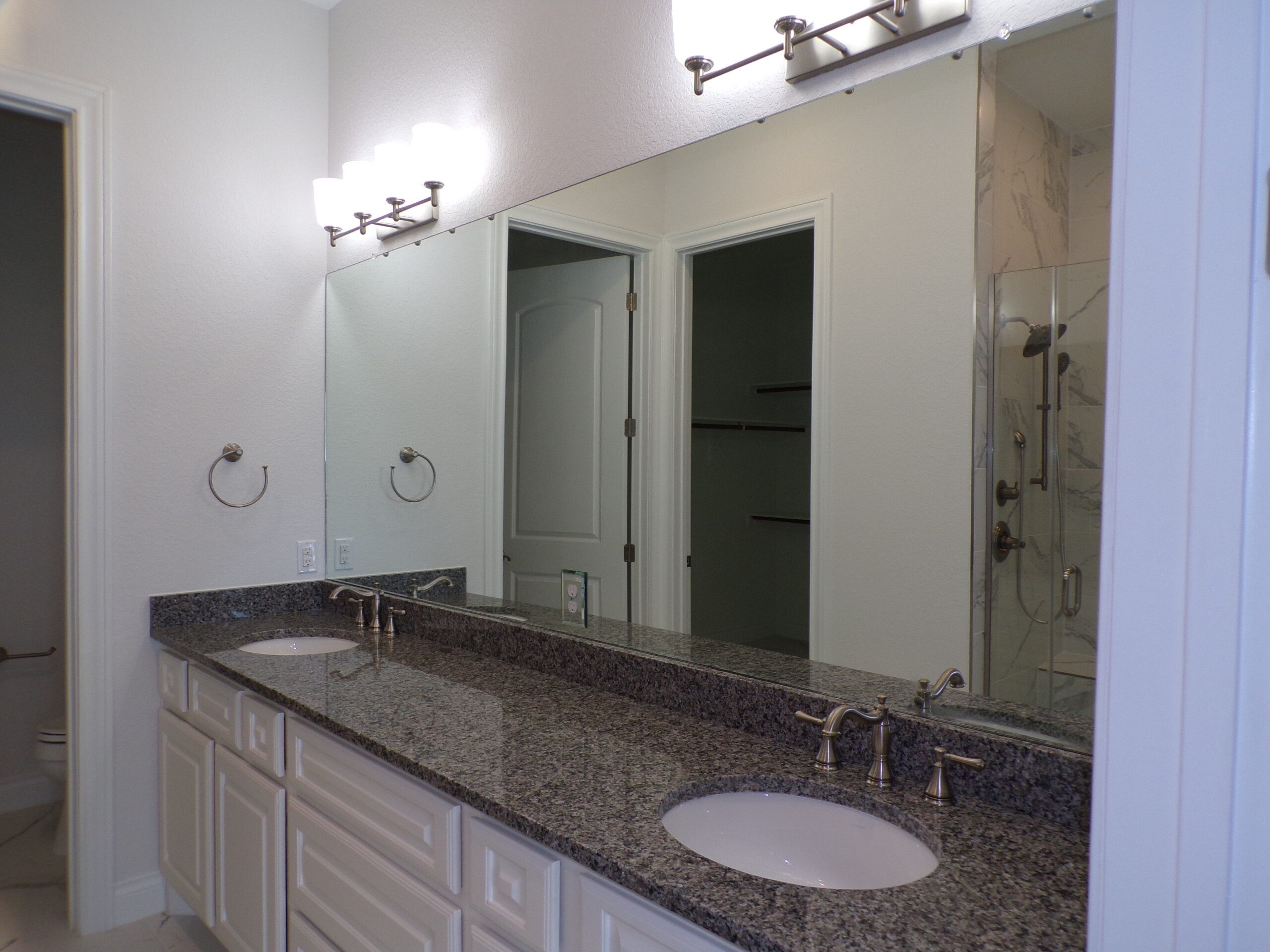 Granite countertop double vanity bathroom.