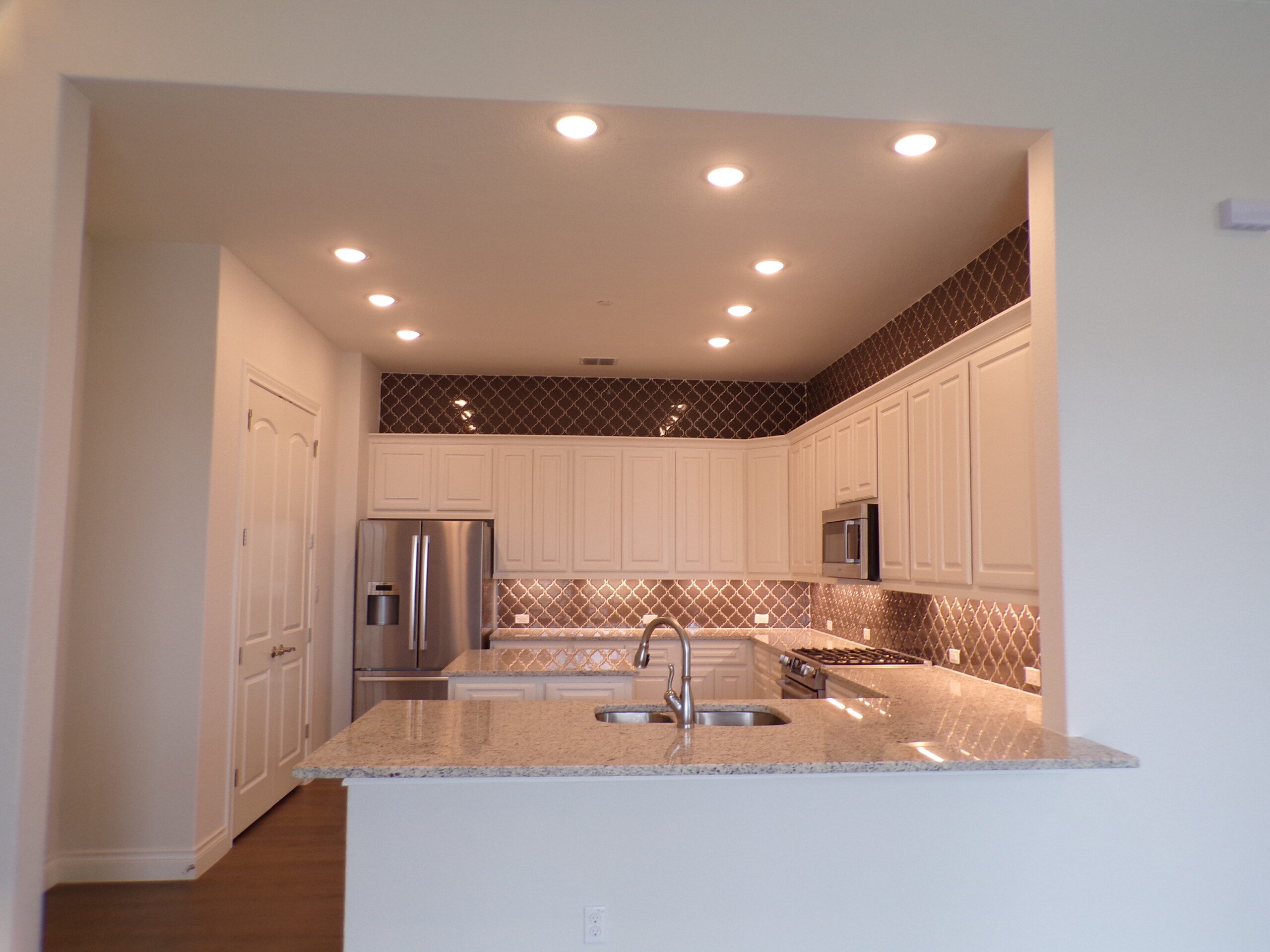 Modern kitchen with granite countertop.
