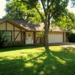 Suburban house with tree shade.