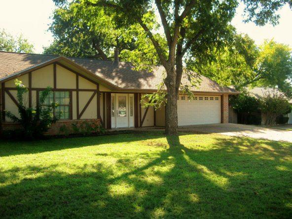 Suburban house with tree shade.