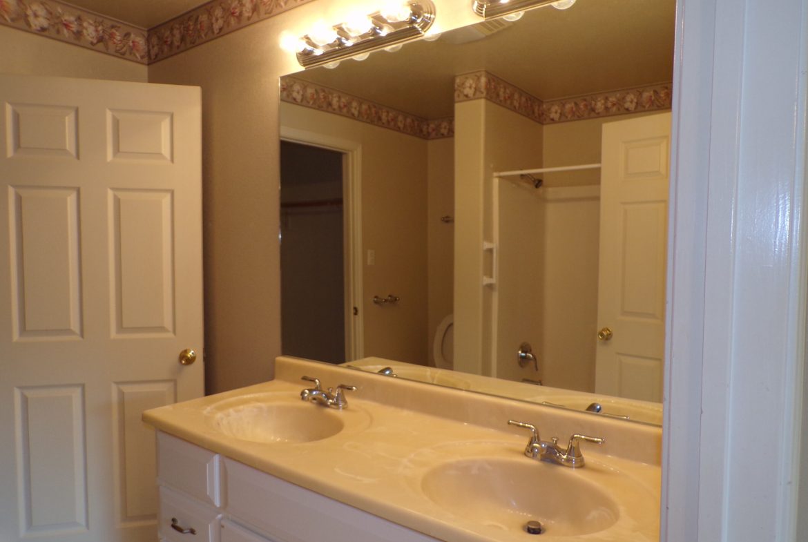 Double vanity bathroom with mirror.