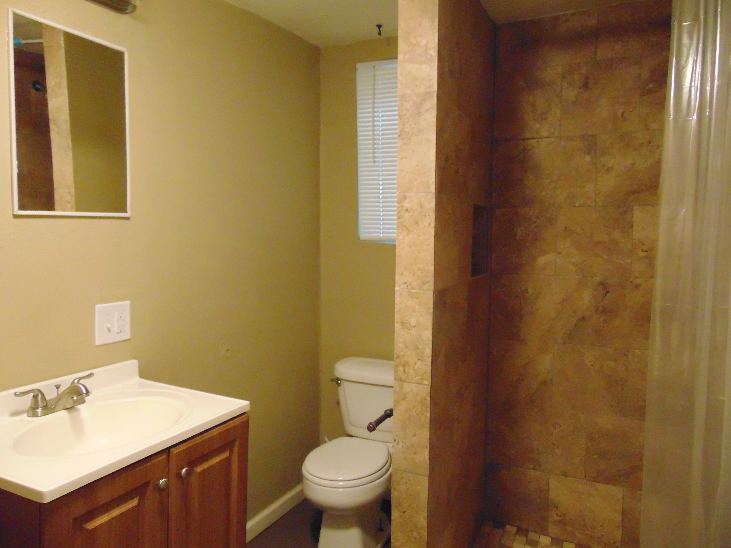 Small bathroom with shower and toilet.