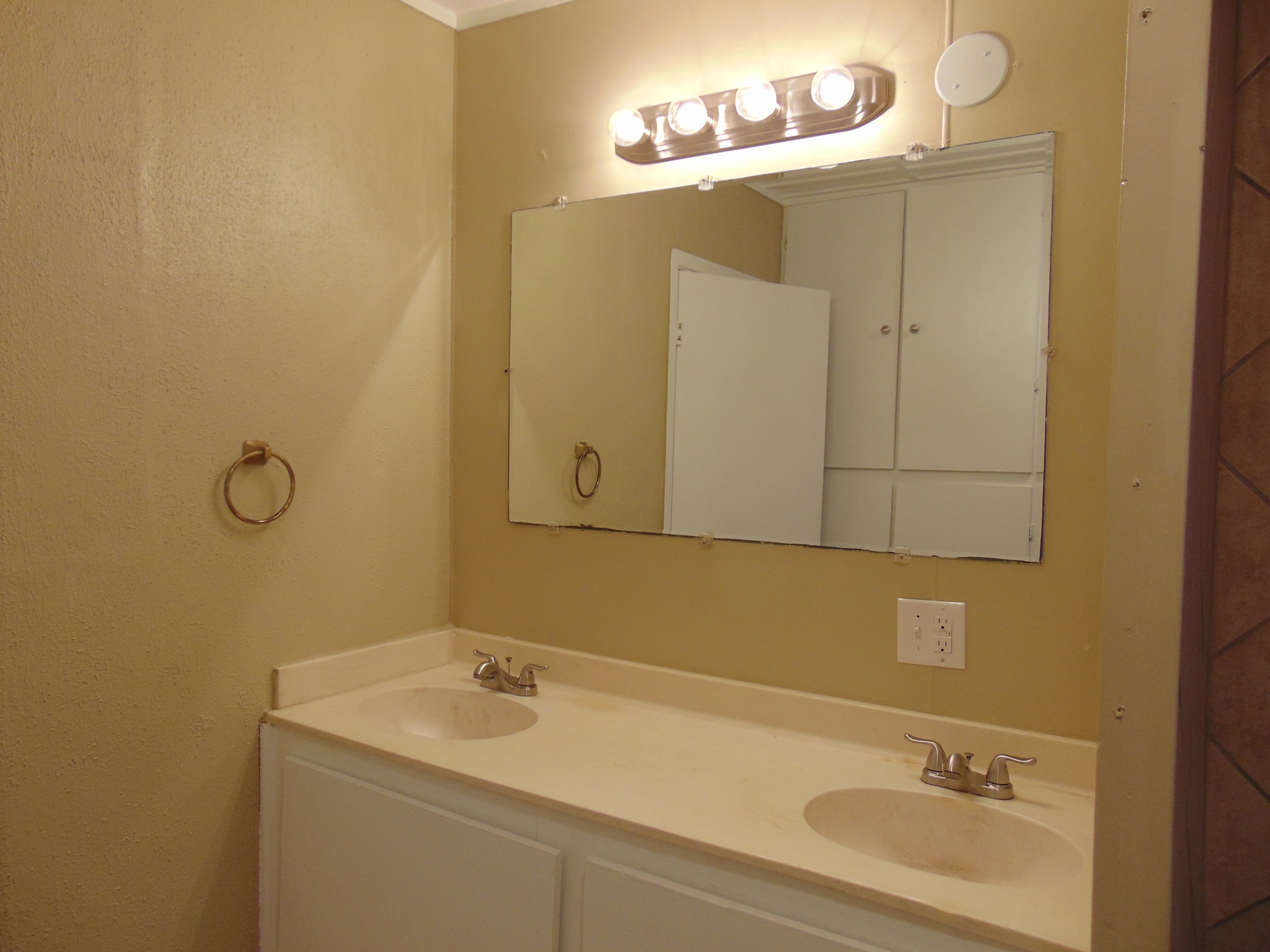 Bathroom with double sinks and mirror.