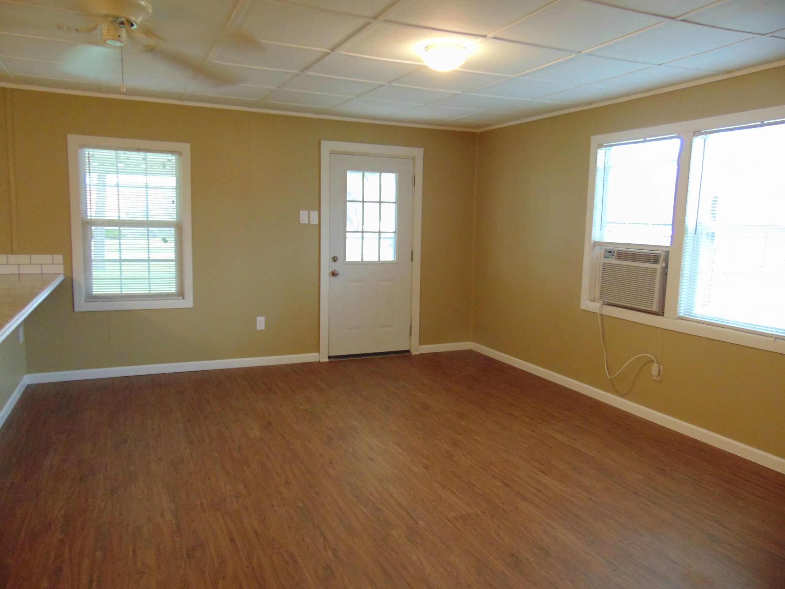 Empty room with wood floor and window.