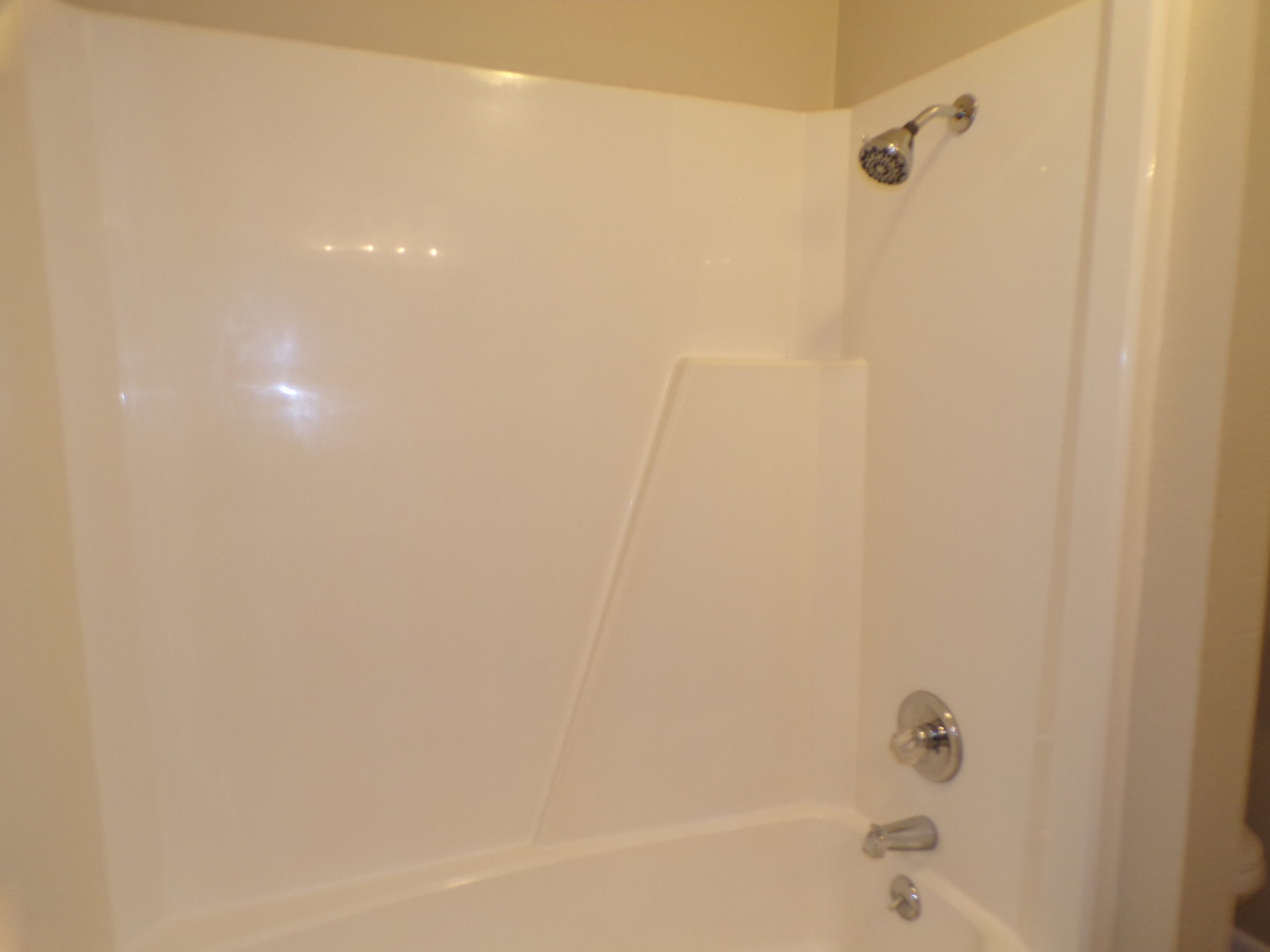 White bathtub and shower combo.