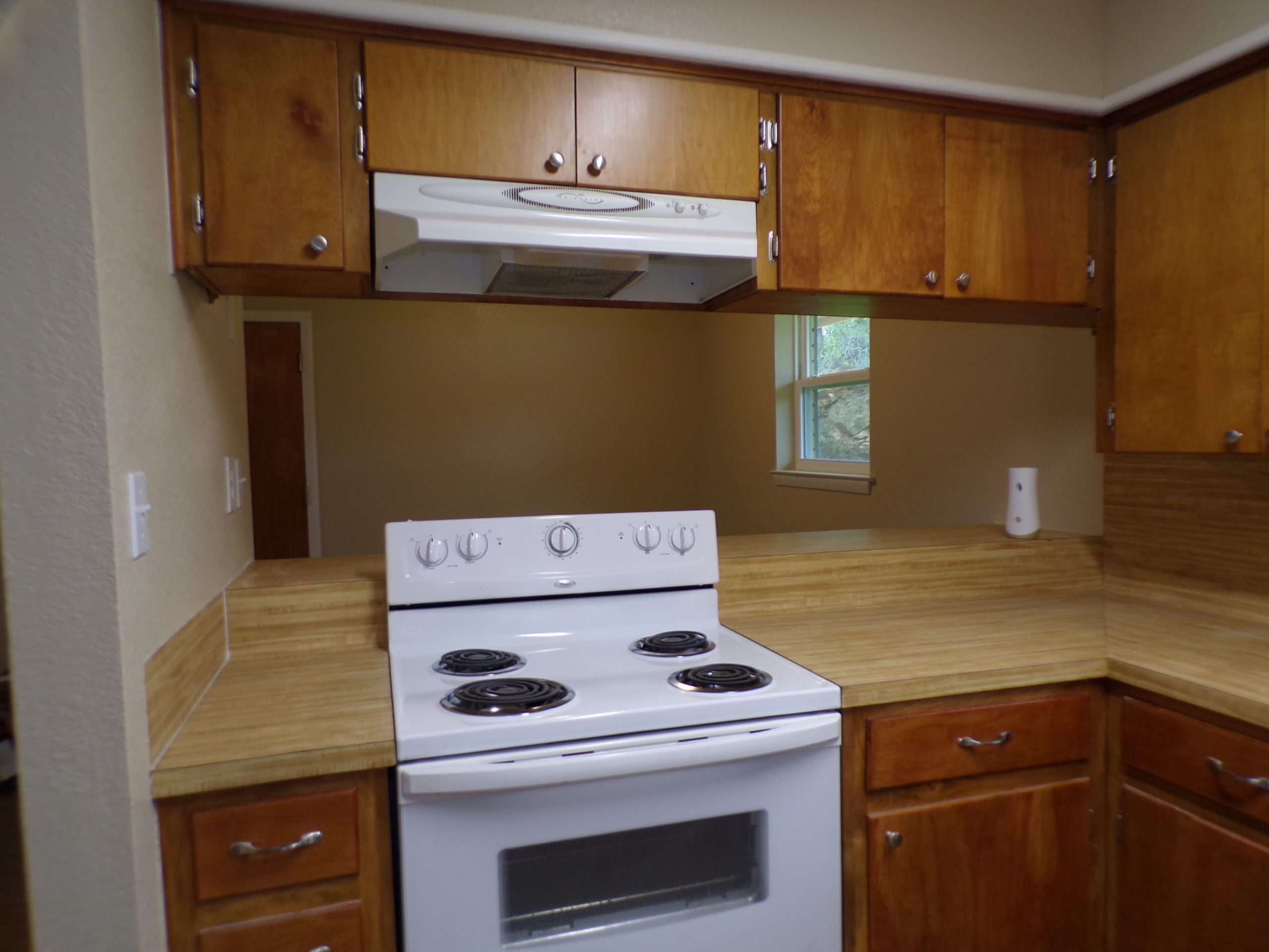 White stove and wood kitchen cabinets.
