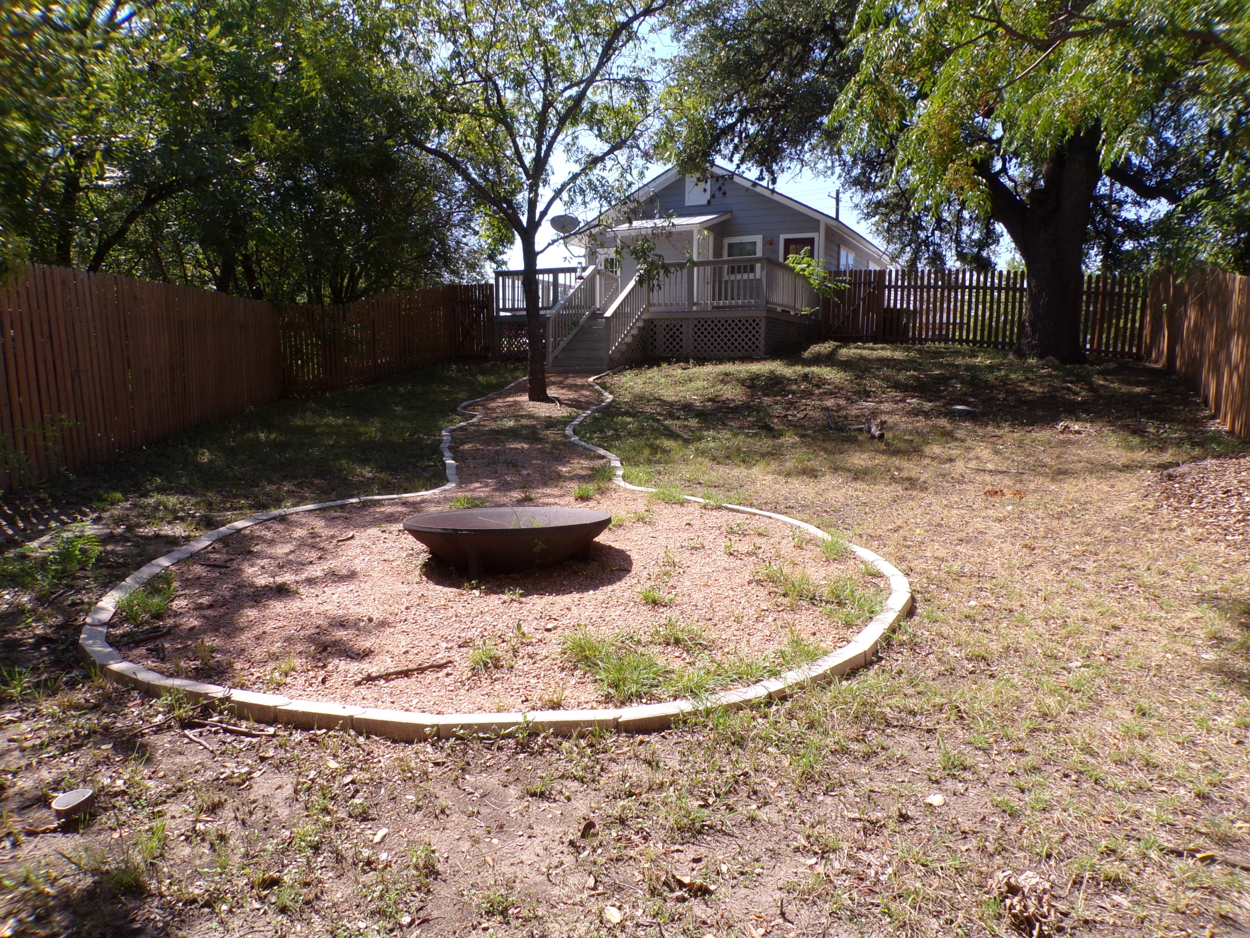 Fire pit and house in backyard.