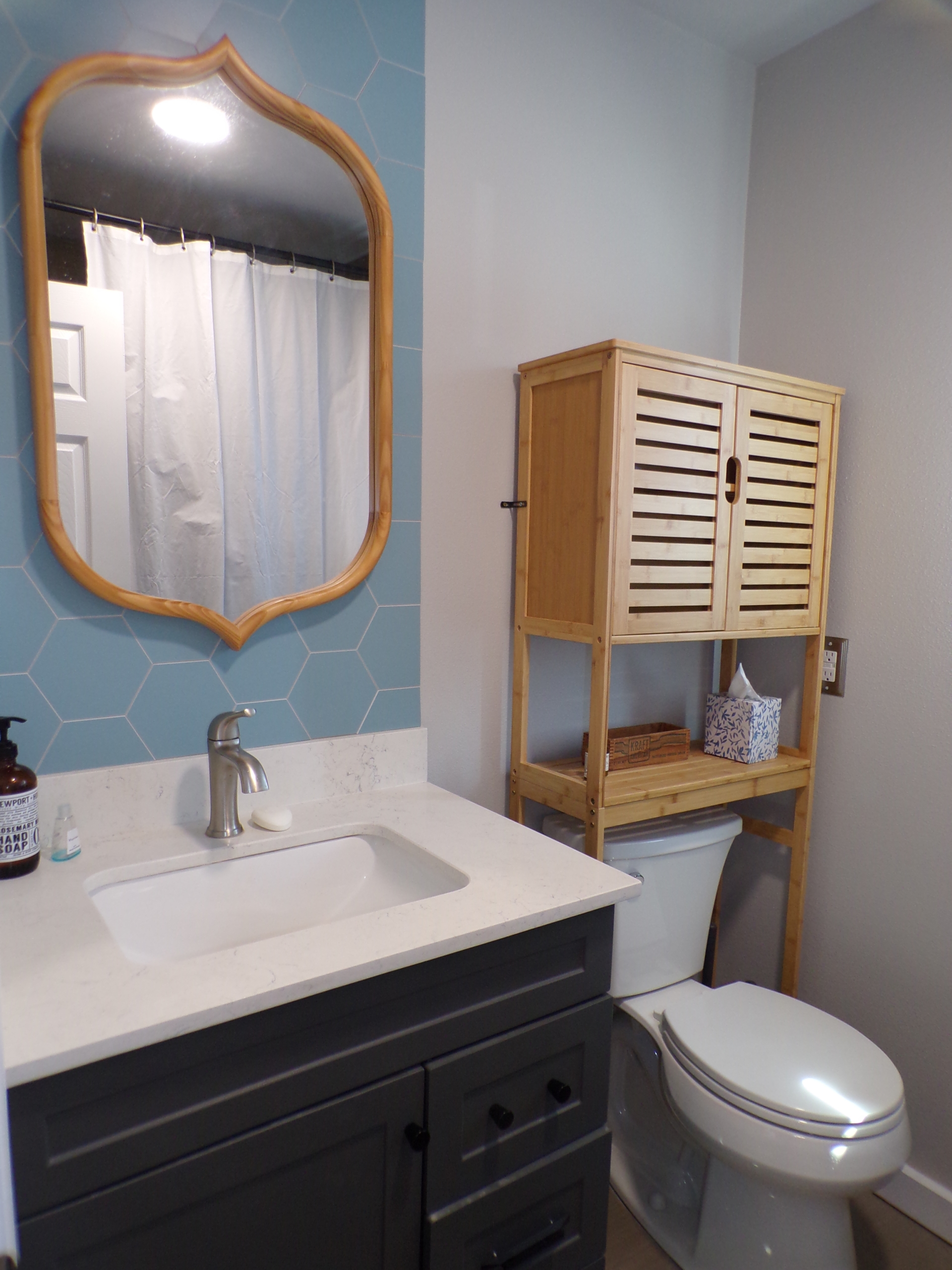 Modern bathroom with blue hex tiles.