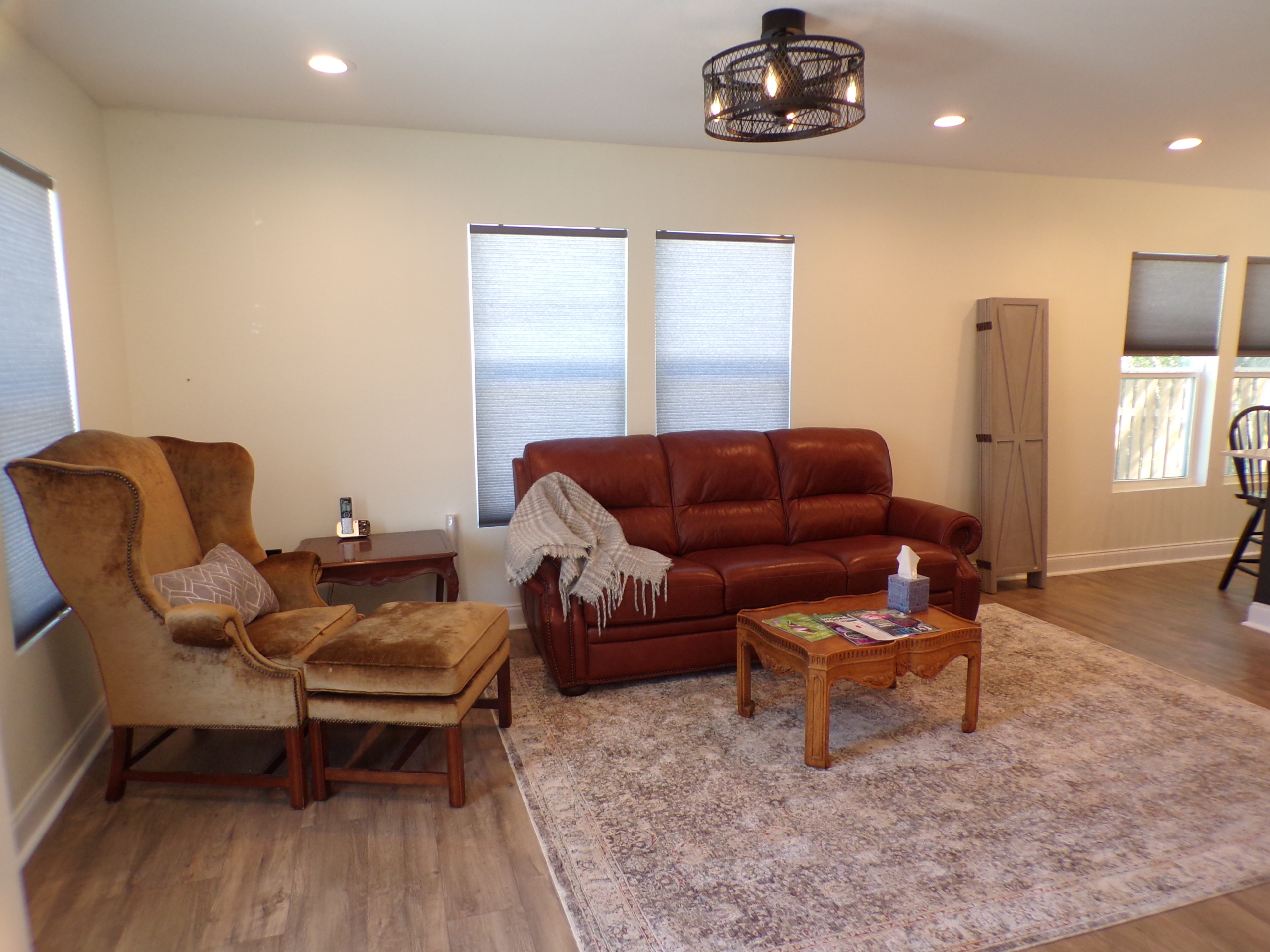 Living room with leather sofa and armchair.