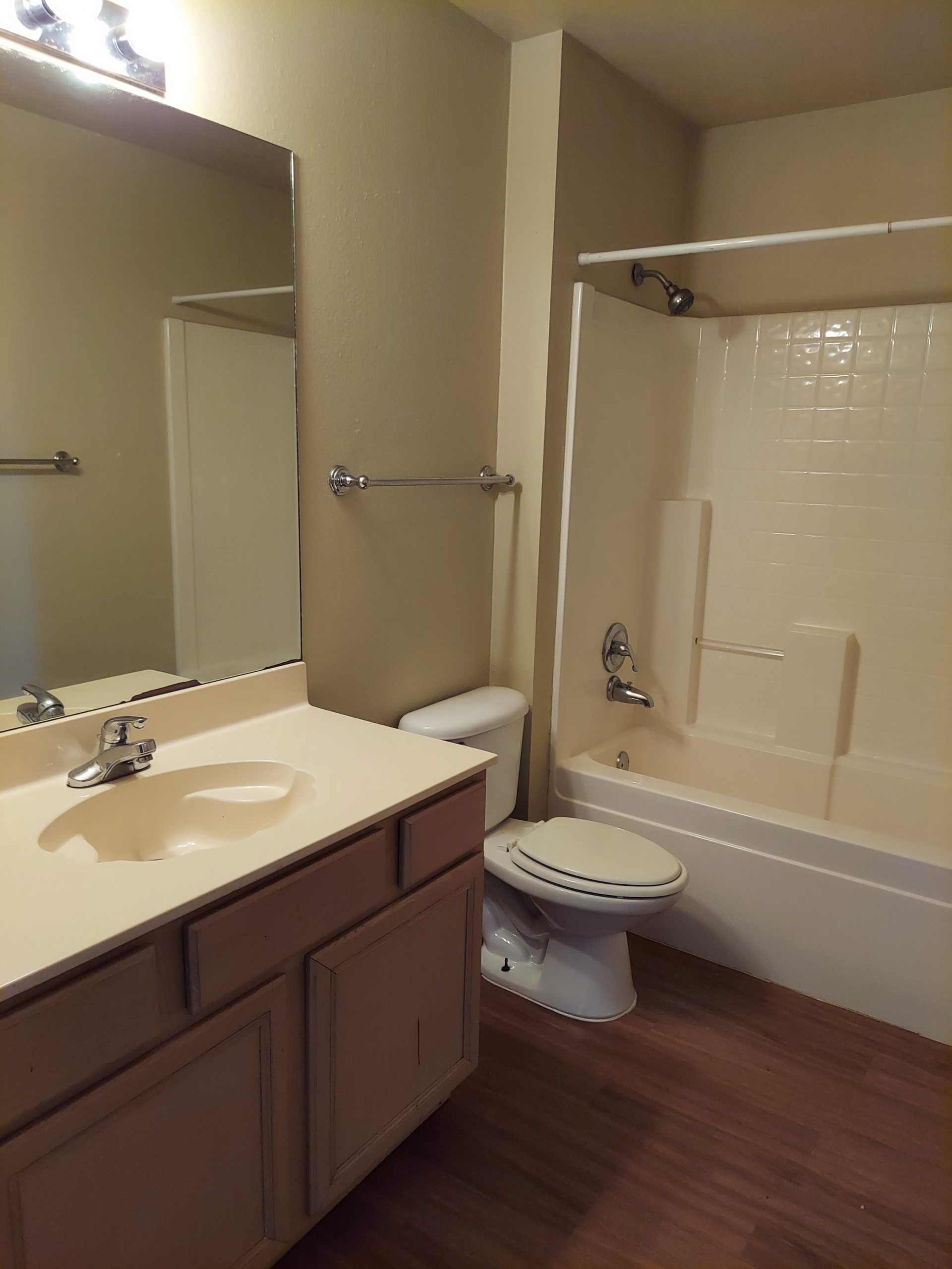 Bathroom with sink, toilet, and shower.