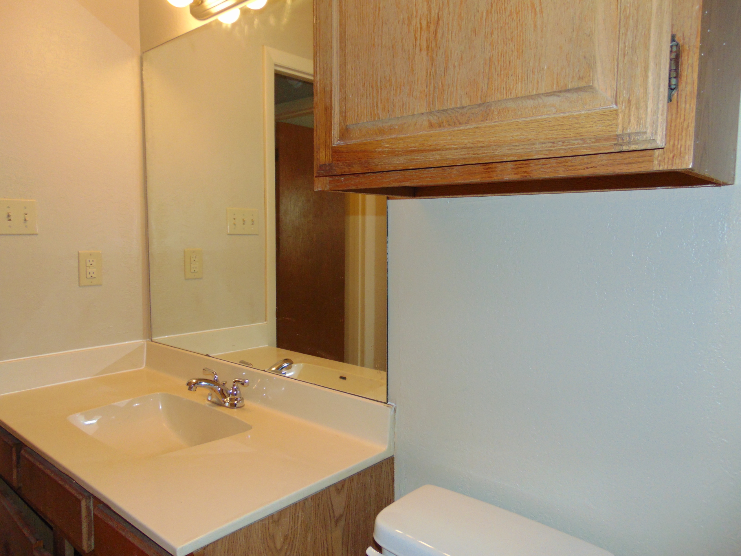Bathroom vanity with sink and mirror.