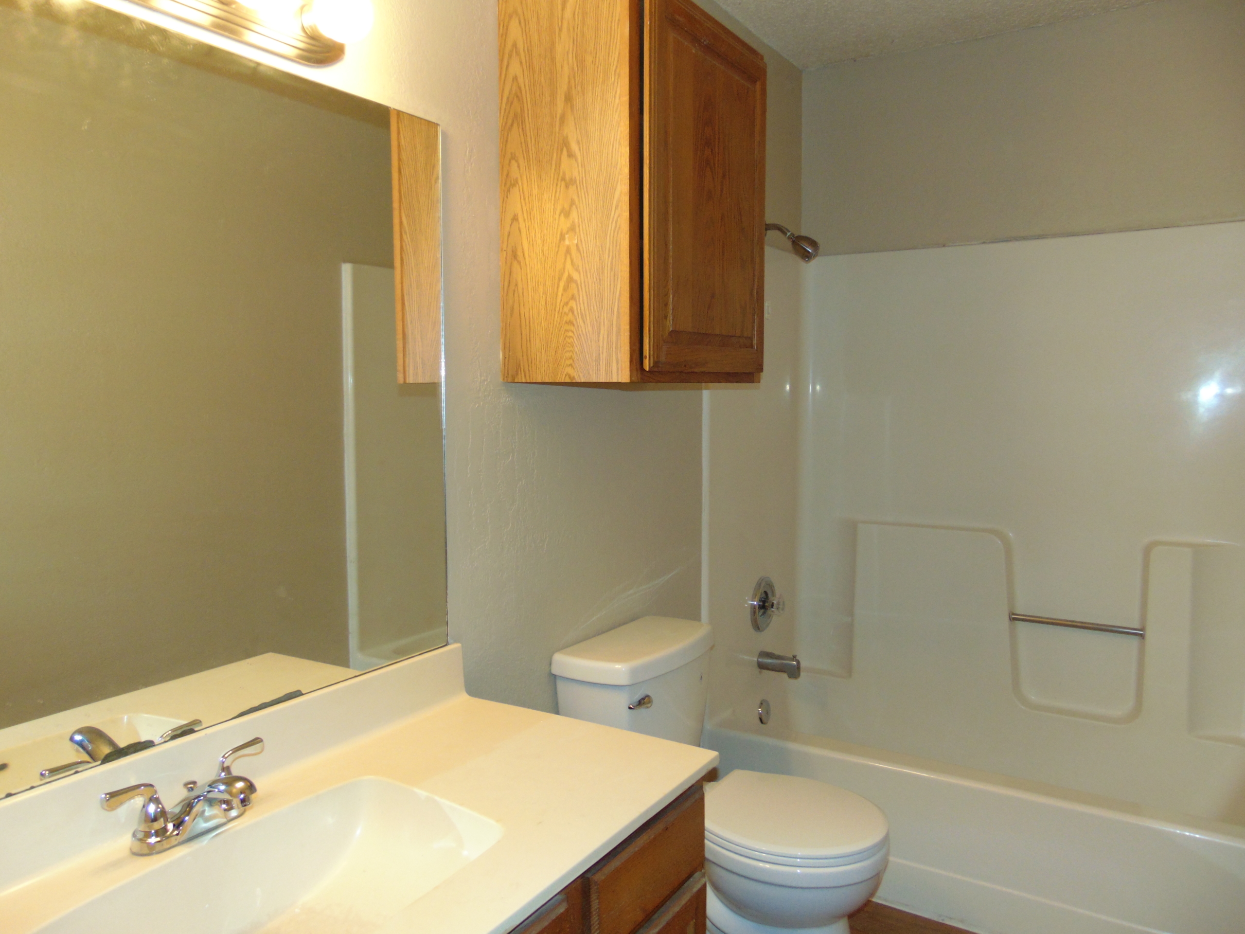 Small bathroom with tub and shower.