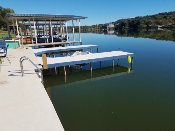 Lake dock with boat lift and swim ladder.